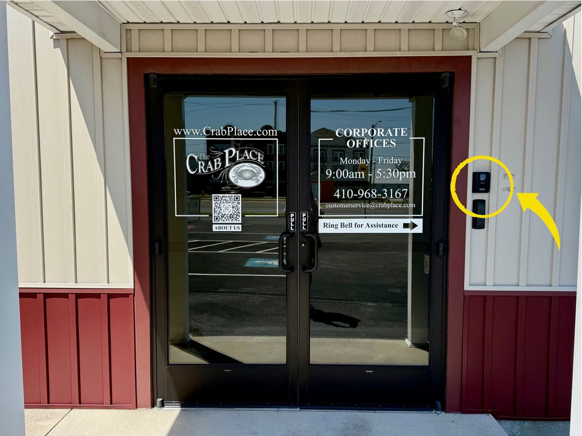 The Crab Place corporate office doors with the ring bell for assistance sign, the bell marked to the right of the doors